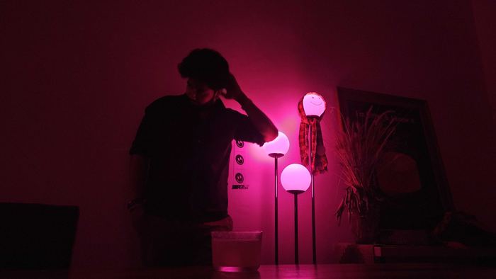 Prathamesh in a magenta-lit room
